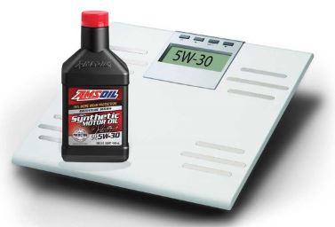 A bottle of AMSOIL motor oil next to a scale.