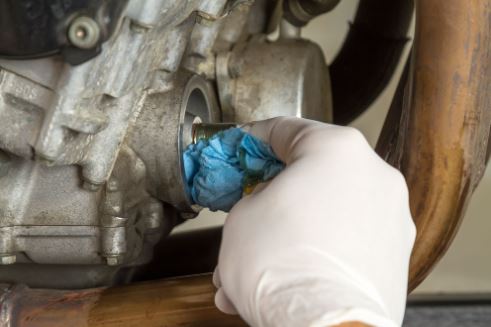 Clean the engine opening around the oil filter base