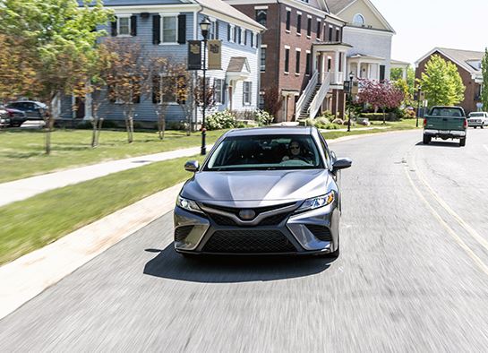 A car travelling on a residential road