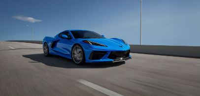 a blue car driving on a highway