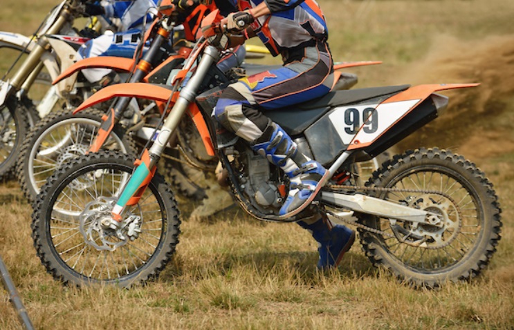 dirt bikes at the start of a dirt path course 