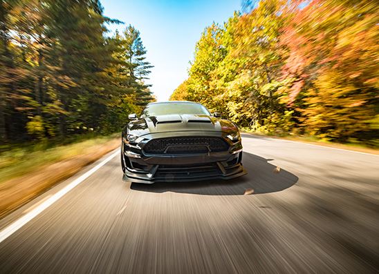 A car driving on a countryside road